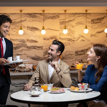 La Clef Champs-Elysees Paris By The Crest Collection Exterior photo A butler serving guests at the lounge